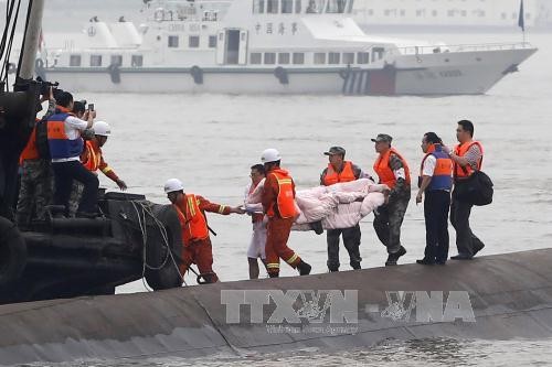 Trung Quốc: Số nạn nhân thiệt mạng trong vụ chìm tàu tăng Chuyển thi thể hành khách trong vụ chìm tàu ngày 2/6. Ảnh: AFP/ TTXVN