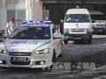 Xe cảnh sát và xe cứu thương mang thi thể "ông Kim Jong-nam" rời bệnh viện ở Putrajaya, Malaysia ngày 15/2. Ảnh: EPA/TTXVN