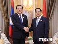 Thủ tướng Phạm Minh Chính gặp Thủ tướng Lào Sonexay Siphandone. (Ảnh: Dương Giang/TTXVN)