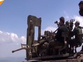 Lực lượng Hồi giáo cực đoan sẵn sàng cho cuộc chiến với quân đội Syria ở Lattakia. Ảnh minh họa video Sputnik.