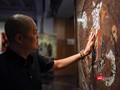 Họa sĩ Trần Ngọc Hưng bên những tác phẩm đang trưng bày tại Ngõ Art Gallery. Ảnh: Phạm Nguyễn
