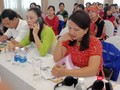 Các đại biểu tại Hội nghị xem sổ theo dõi sức khỏe bà mẹ và trẻ em