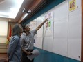 Các thành viên Hội đồng chấm thi xem xét, đánh giá và lựa chọn các mẫu tem Tết. Ảnh: MIC.gov.vn