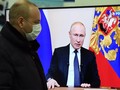 Một người dân theo dõi ông Putin phát biểu trên truyền hình (Ảnh: Sputnik)