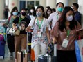 Hành khách nhập cảnh tại sân bay. Ảnh: Reuters