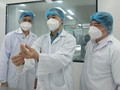 Các chuyên gia kiểm tra vaccine phòng COVID-19 (Ảnh - Anh Văn)