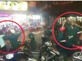 Hình ảnh nhóm dân quân dùng dùi cui đuổi đánh các thanh niên. Ảnh cắt từ clip.