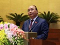Thủ tướng Nguyễn Xuân Phúc trình bày báo cáo trước Quốc hội. Ảnh VGP/Nhật Bắc