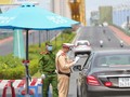 Lực lượng công an tại chốt kiểm soát dịch trên địa bàn TP Đà Nẵng kiểm tra giấy đi đường của người dân