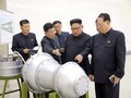 Nhà lãnh đạo Triều Tiên Kim Jong Un đứng trước một thiết bị được cho là đầu đạn hạt nhân thu nhỏ (Ảnh AP)