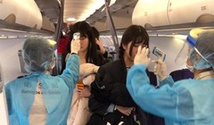 Đề phòng dịch bệnh lây lan, các nhân viên y tế sân bay Ma Cao lên máy bay đo thân nhiệt mọi hành khách trên chuyến bay từ Vũ Hán đến. (Ảnh: Đông Phương).