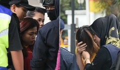 Đoàn Thị Hương  (phải, che mặt) và Siti Aisyah được dẫn tới Tòa