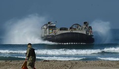 Một giám lộ viên đang dẫn đường tàu đổ bộ đêm khí trong diễn tập đổ bộ ngày 05.09, 2015. (Photo / CFP)