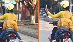 Mẹ đèo con nhỏ vẫn vô tư dùng điện thoại