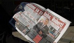 Một người đàn ông trưng bài báo mô tả chi tiết vụ tấn công Thủ tướng Slovakia Robert Fico ngày 16/5/2024 (Ảnh: Getty)