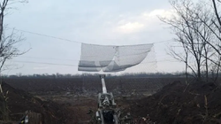Lưới thép được quân đội Ukraine giăng phía trên khẩu pháo xe kéo để bảo vệ nó khỏi bị UAV tự sát Lancet-3 tiêu diệt (Ảnh: QQ).