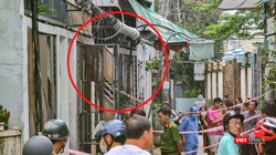 Lực lượng Công an đang phong toả hiện trường căn nhà (khoanh đỏ) bị cháy để điều tra