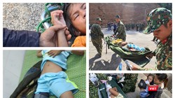 Lực lượng quân đội sơ cứu, đưa nạn nhân đi bệnh viện (Ảnh Hoà Bình)