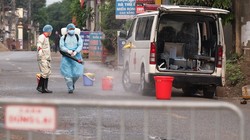 Lực lượng chức năng phun khử khuẩn phía trước ngôi nhà bệnh nhân 243. Ảnh: CDC Hà Nội.