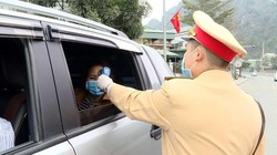 Công an TP Cẩm Phả vừa điều tiết giao thông vừa kết hợp với đo nhiệt độ người tham gia giao thông. Ảnh: UBND tỉnh Quảng Ninh.