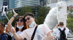 Du khách chụp ảnh tại công viên Merlion, Singapore (Ảnh: SCMP)