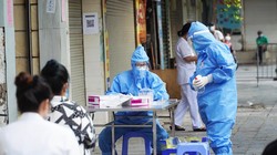 Nhân viên y tế lấy mẫu xét nghiệm COVID-19 cho người dân ở khu vực bên ngoài Bệnh viện Hữu nghị Việt Đức (Ảnh - Minh Nhân) 