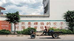 Quảng cáo với nội dung: "Tay trái siêng năng kiếm tiền, tay phải tiết kiệm với Taobao nông thôn". Ảnh: Bloomberg