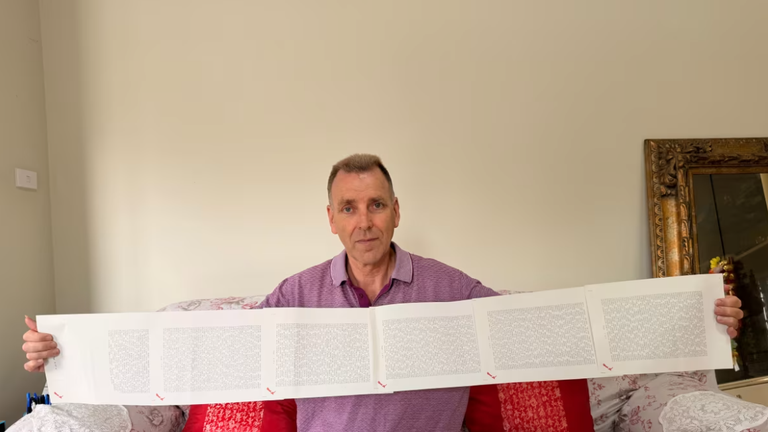 Laurence Watkins, một nhân viên bảo vệ đã nghỉ hưu đến từ Auckland, New Zealand, cầm trên tay giấy khai sinh dài 6 trang, trong đó ghi đầy đủ 2.253 cái tên của ông. Ảnh: CNN.
