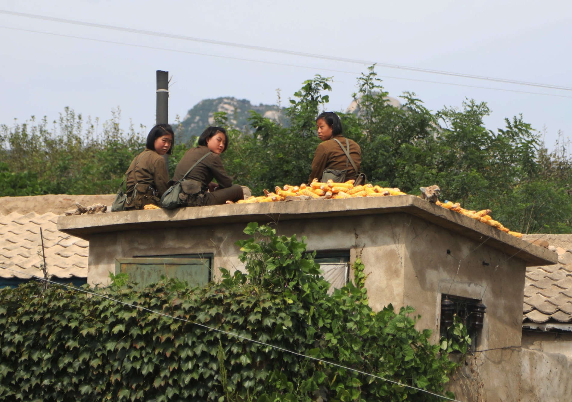 2B5A0207-young-soldier-girls-hanging-out-on-roof-and-drying-corn2-1.jpg