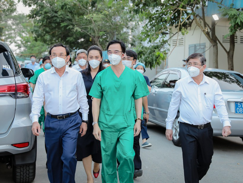 Ông Nguyễn Văn Nên – Bí thư thành ủy Tp.HCM (áo trắng bên trái), ông Nguyễn Thành Phong – Chủ tịch UBND Tp.HCM (áo trắng bên phải) đến thăm Trung tâm Hồi sức tích cực người bệnh Covid-19 trực thuộc Bệnh Viện Bạch Mai, tại Tp.HCM