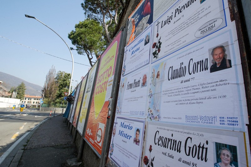 Những tờ cáo phó dán trên bảng tin ở một dãy phố (Ảnh: AP)