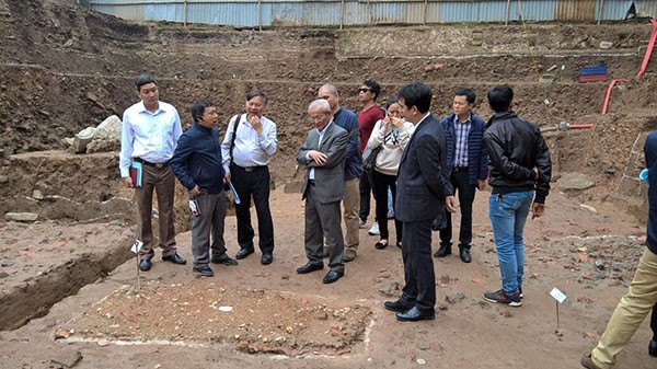 Các nhà khảo cổ quan sát một móng cột thời Lý nằm dưới đáy hồ nước thời Lê Trung hưng tại Hoàng thành Thăng Long