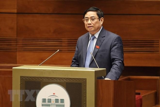 Hình ảnh Thủ tướng Chính phủ Phạm Minh Chính trình bày Báo cáo kết quả thực hiện kế hoạch phát triển kinh tế-xã hội năm 2021; dự kiến kế hoạch phát triển kinh tế-xã hội năm 2022. (Ảnh: Dương Giang/TTXVN)