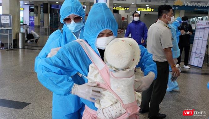 Vợ chồng Nguyễn Công Chính trở về quê nhà với 2 &quot;tài sản&quot; lớn nhất, một bé còn đang phải địu trước ngực ba Chính. Ảnh: GVT.