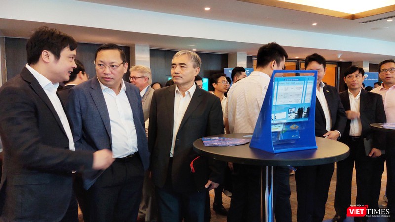 Ông Nguyễn Minh Hồng - Chủ tịch Hội Truyền thông số Việt Nam trao đổi tại các gian hàng trưng bày CNTT (Ảnh: Hòa Bình) 