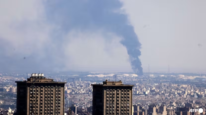 Khói bốc lên từ một nhà máy lọc dầu sau cuộc tấn công của Israel vào thủ đô Tehran của Iran vào ngày 17/6. Ảnh: AFP. Trump ra toi hau thu voi Iran.png