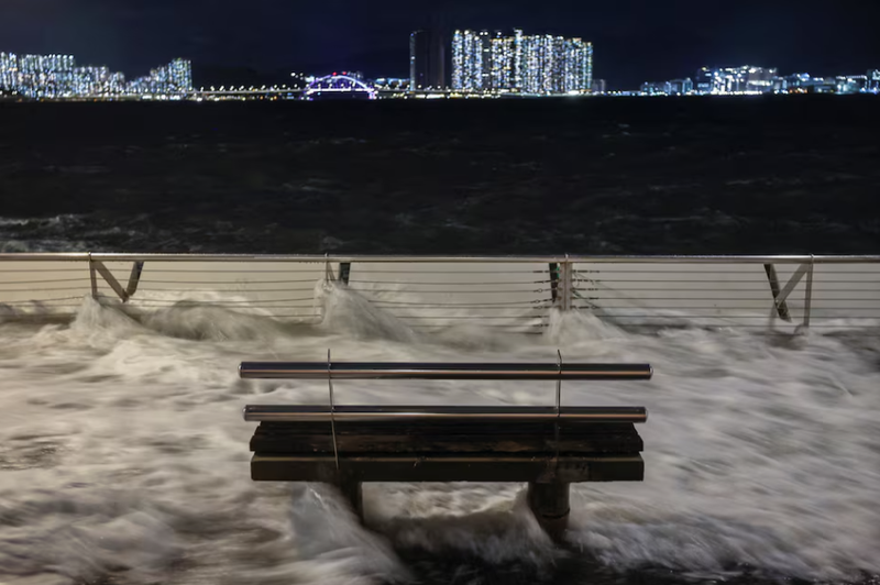 Sóng do siêu bão Ragasa đập vào ghế trên bờ biển ở Hong Kong. Ảnh: Reuters. Siêu bão Ragasa tàn phá Hong Kong, 700 chuyến bay bị hủy 3.png