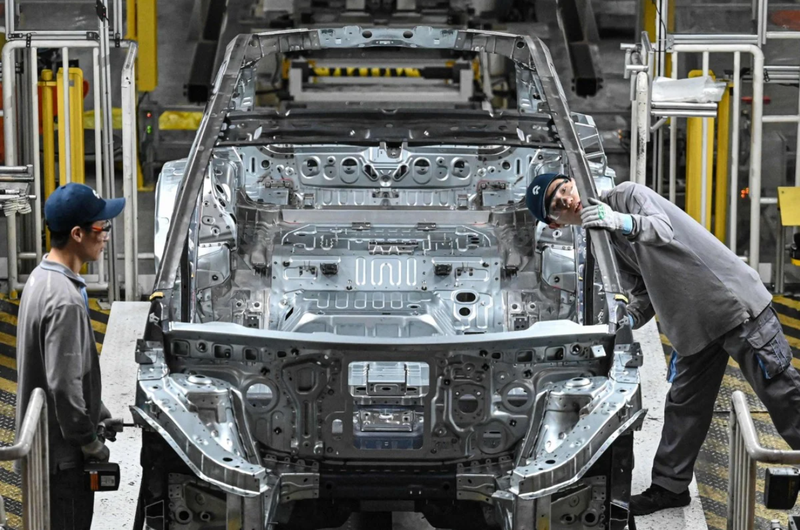 Nhân viên làm việc trên dây chuyền sản xuất xe điện tại nhà máy của hãng sản xuất ô tô Trung Quốc NIO ở Hợp Phì, tỉnh An Huy, miền Đông Trung Quốc vào ngày 24/9. Ảnh: AFP.