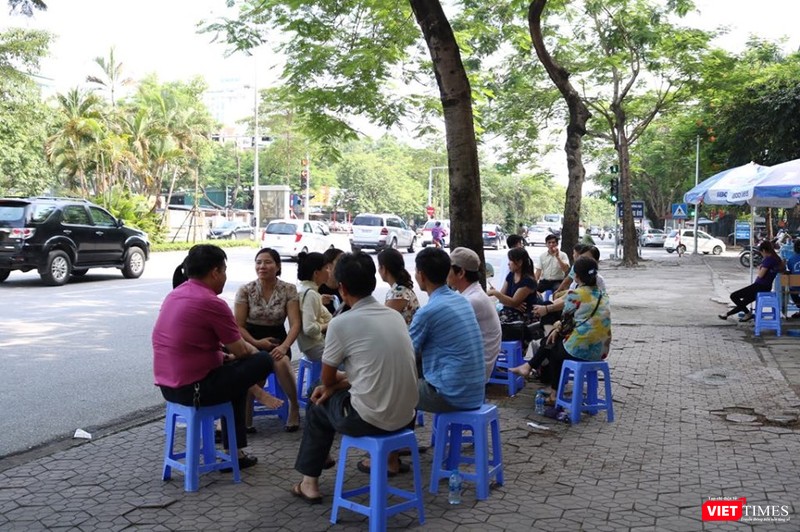 Phụ huynh tránh nóng đợi con thi xong. Ảnh: Minh Thúy