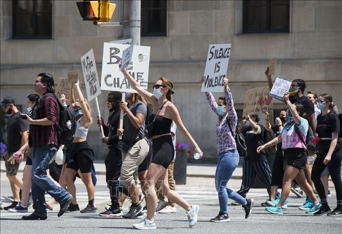 Người dân Canada tuần hành chống phân biệt chủng tộc. Ảnh: TTXVN Người dân Canada tuần hành chống phân biệt chủng tộc. Ảnh: TTXVN