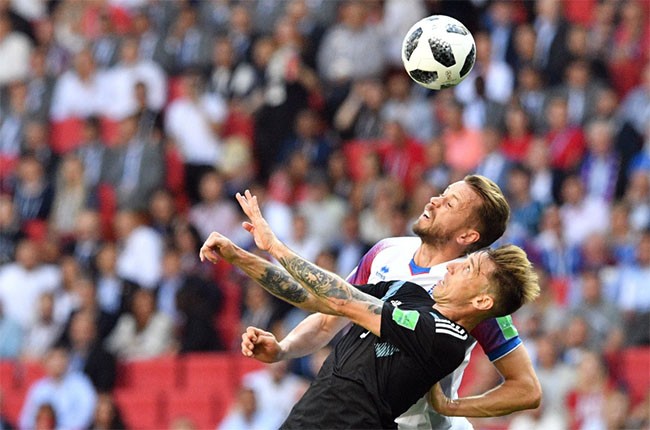 Lucas Biglia của Argentina tranh bóng trên cao với Kari Arnason của Iceland.