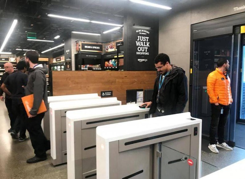 Khách hàng đang quét ứng dụng bằng điện thoại thông minh để vào cửa hàng Amazon Go.