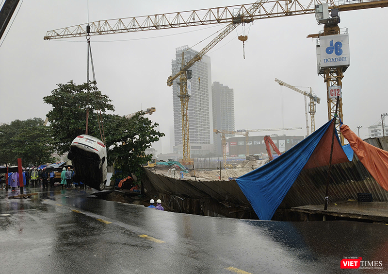 Lực lượng cứu hộ cẩu kéo ô tô bị hố tử thần nuốt chửng.