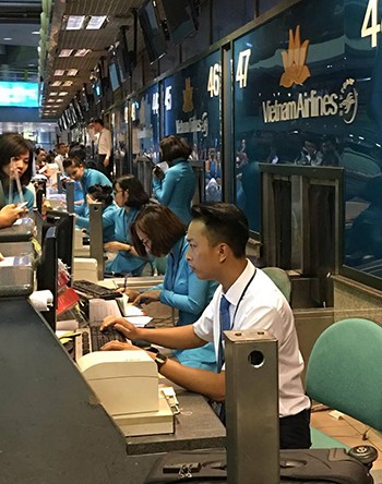 Các nhân viên sân bay phải làm thủ tục hàng không bằng thủ công, toàn bộ màn hình, mạng nội bộ đã bị tắt. Ảnh: Hùng Sơn.