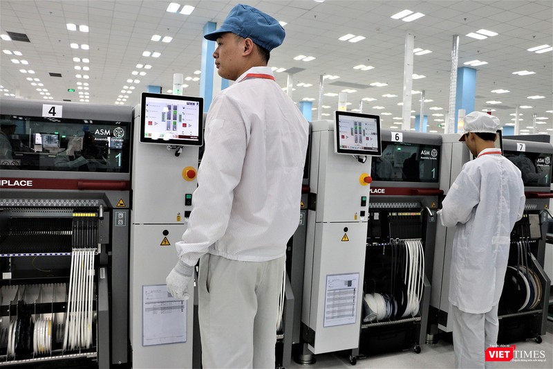 Công nhân phụ trách dây chuyền in bảng mạch. Loại máy gắn chip lên bo mạch được đặt mua tại Đức