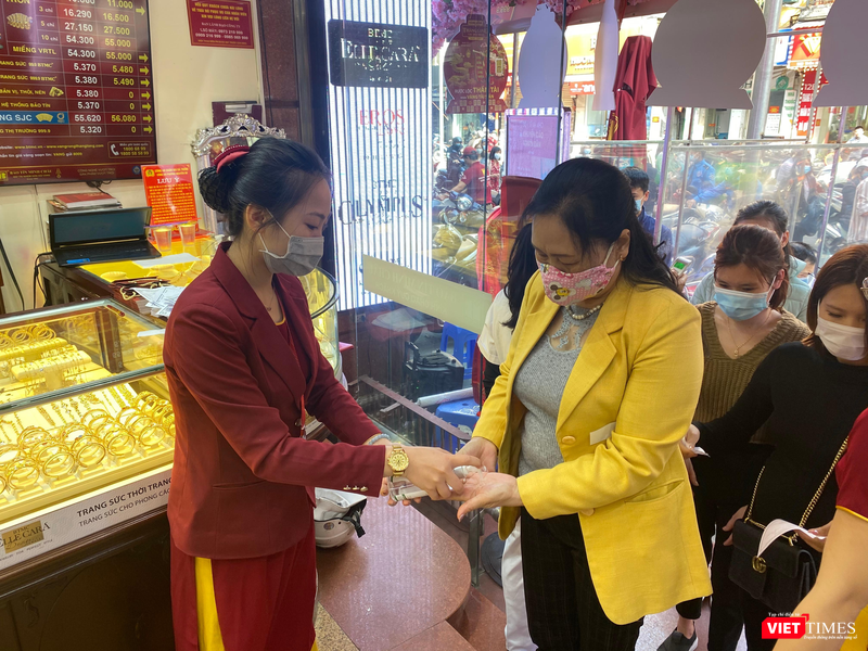 Khách hàng được đo nhiệt độ và sát khuẩn tay trước khi vào cửa hàng Khách hàng được đo nhiệt độ và sát khuẩn tay trước khi vào cửa hàng