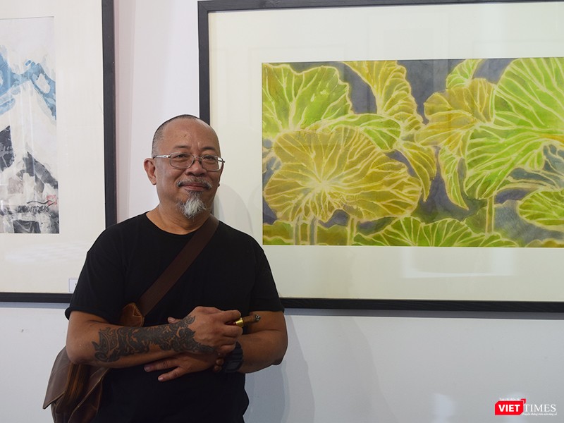 Họa sĩ Bùi Việt Dũng bên các tác phẩm đang trưng bày tại "Tứ diện cũ"