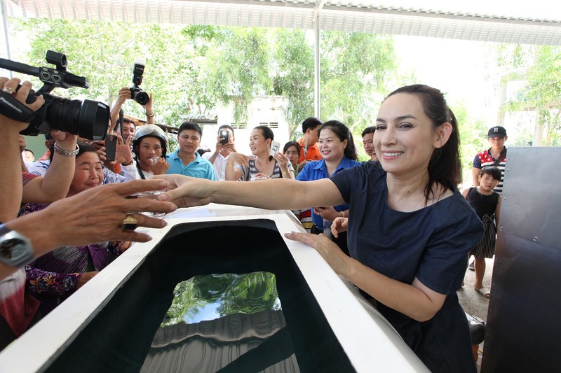 Ca sĩ Phi Nhung_Đại sứ chương trình Nước ngọt nghĩa tình trao nước ngọt sau khi lọc cho người dân uống thử.jpg Bỏ file này