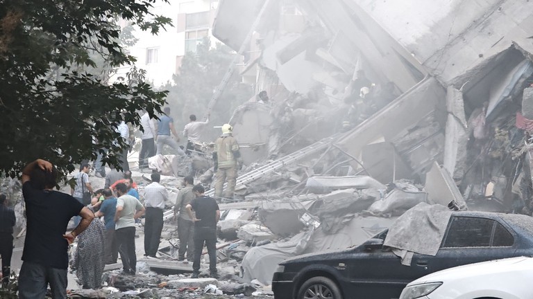 Mọi người nhìn vào thiệt hại của các tòa nhà tại Quảng trường Nobonyad sau cuộc không kích của Israel vào ngày 13/6 tại Tehran, Iran. Ảnh: Getty.