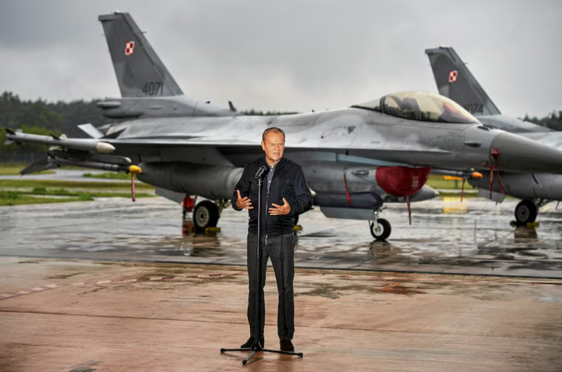Thủ tướng Ba Lan Donald Tusk đứng trước các máy bay chiến đấu F-16 của Không quân Ba Lan khi ông tổ chức họp báo về mối đe dọa từ UAV Nga tại Căn cứ Không quân Chiến thuật số 32 ở Lask, cách Lodz, Ba Lan khoảng 30 km về phía tây nam, ngày 11/9. Ảnh: Reuters.